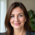 Portrait of Elena Petrova, a Certified Nutritionist smiling warmly.